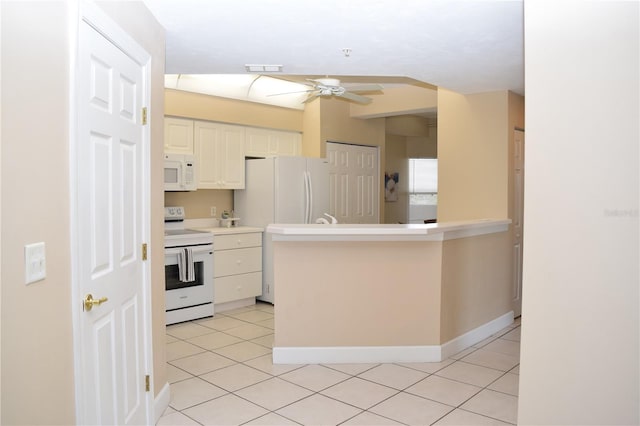 kitchen with a peninsula, white appliances, a ceiling fan, light tile patterned floors, and white cabinets