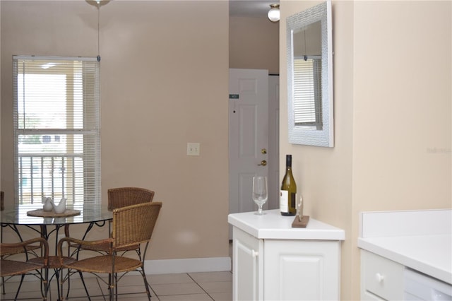 interior space with a healthy amount of sunlight, baseboards, and light tile patterned floors
