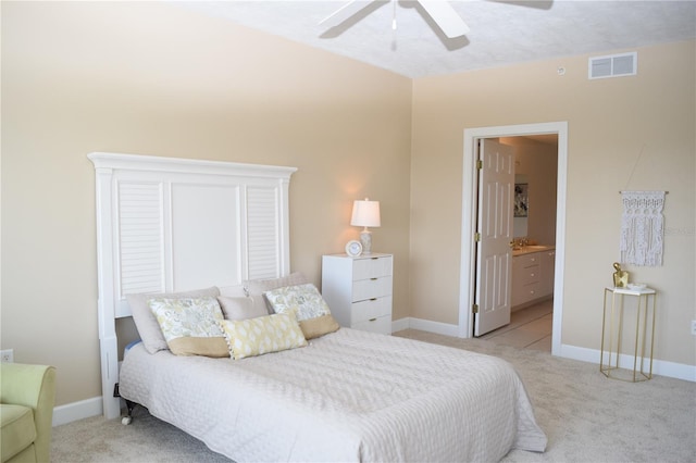 bedroom featuring a ceiling fan, baseboards, visible vents, connected bathroom, and light colored carpet