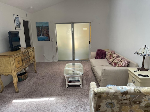 carpeted living room with vaulted ceiling and baseboards