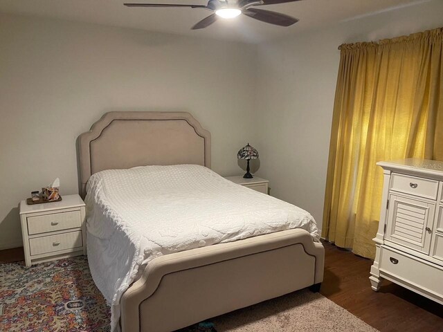 bedroom with ceiling fan and dark wood-style floors
