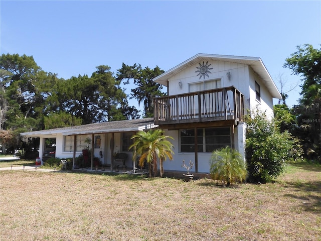 view of front of property with a front lawn and a balcony