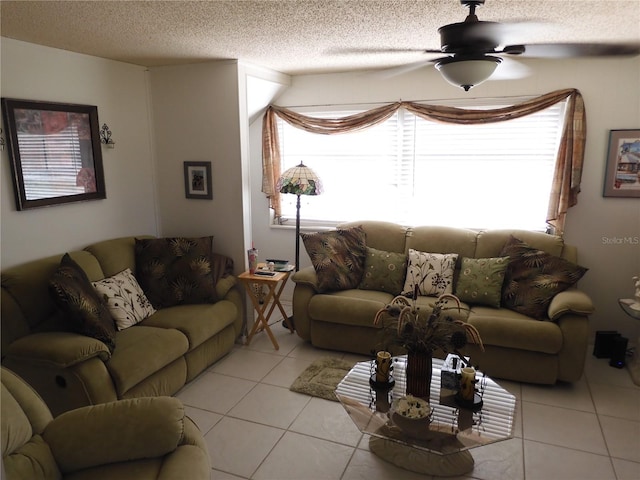 living area featuring light tile patterned flooring, a textured ceiling, and ceiling fan
