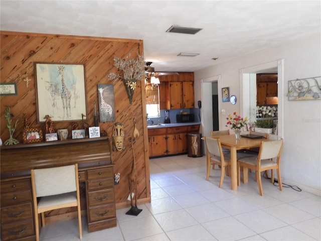 dining room featuring wooden walls