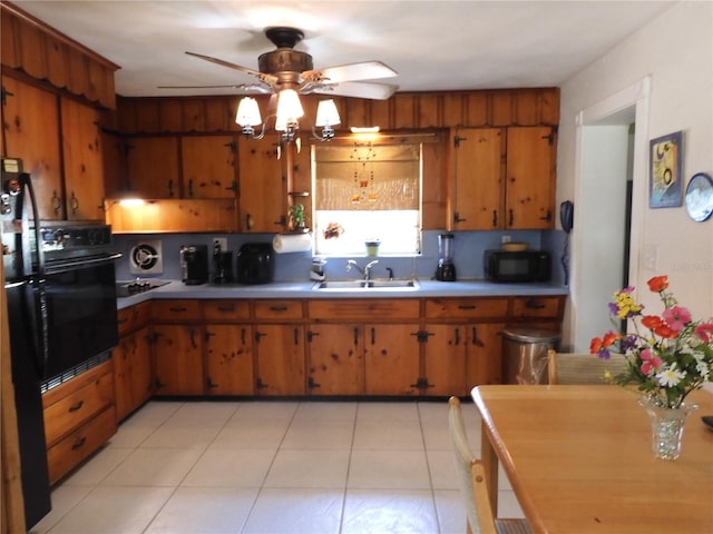 kitchen featuring a sink, black appliances, a ceiling fan, light countertops, and brown cabinetry