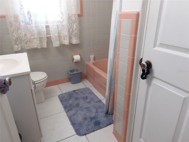 full bathroom with tile walls, vanity, toilet, tile patterned floors, and shower / bath combo