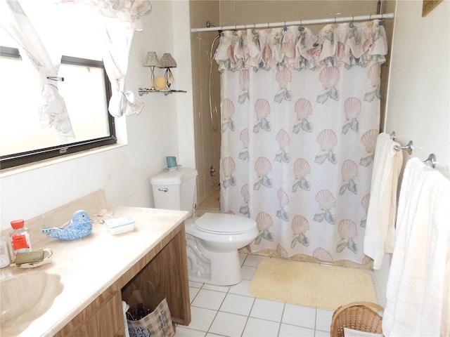 bathroom featuring vanity, tile patterned flooring, and toilet