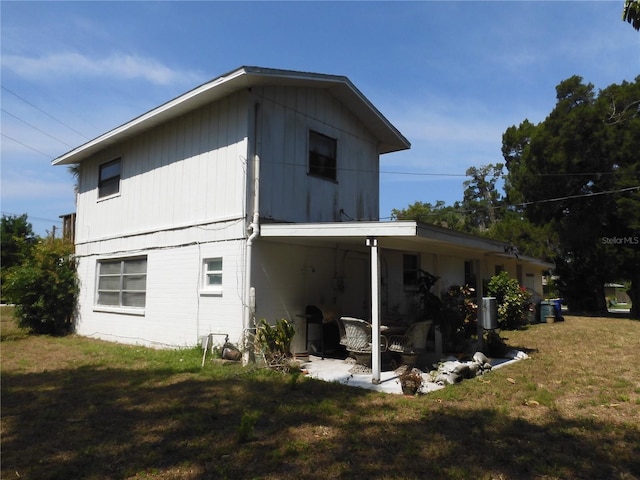 back of property with a lawn