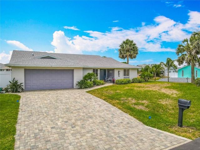 31 Sea Harbor Dr E, Ormond Beach, FL 32176 - single story home with a front lawn, decorative driveway, a garage, and a shingled roof