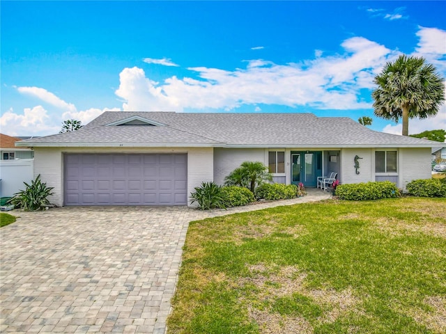 31 Sea Harbor Dr E, Ormond Beach, FL 32176 - ranch-style house with a front lawn, an attached garage, decorative driveway, brick siding, and a shingled roof