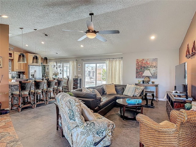 31 Sea Harbor Dr E, Ormond Beach, FL 32176 - living room featuring a ceiling fan, a textured ceiling, lofted ceiling, light stone finish floors, and recessed lighting