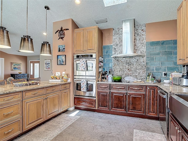 31 Sea Harbor Dr E, Ormond Beach, FL 32176 - kitchen with wall chimney range hood, appliances with stainless steel finishes, tasteful backsplash, light stone counters, and hanging light fixtures