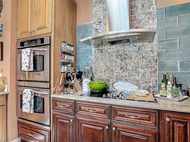 31 Sea Harbor Dr E, Ormond Beach, FL 32176 - kitchen with wall chimney exhaust hood, stainless steel double oven, decorative backsplash, and black electric cooktop