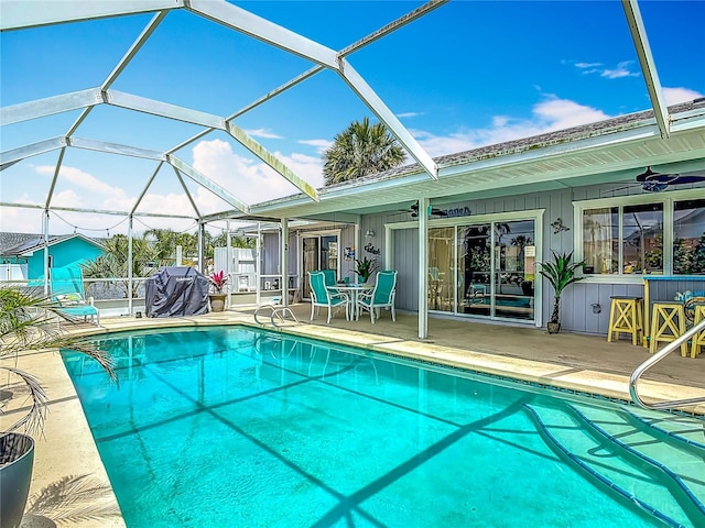 31 Sea Harbor Dr E, Ormond Beach, FL 32176 - outdoor pool featuring a patio area, a ceiling fan, a lanai, and area for grilling