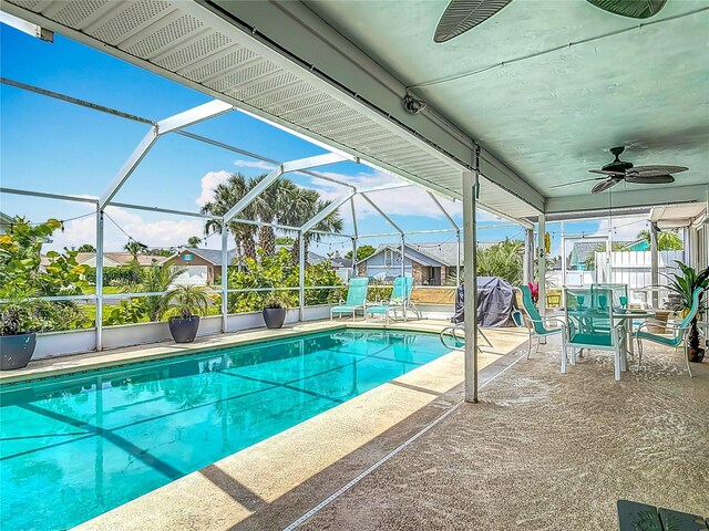 31 Sea Harbor Dr E, Ormond Beach, FL 32176 - swimming pool with a patio area, ceiling fan, glass enclosure, and fence