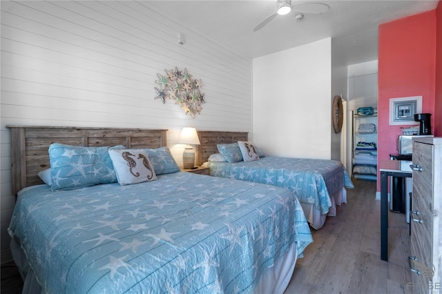 3509 S Atlantic Ave Unit 102And 103, New Smyrna Beach, FL 32169 - bedroom with hardwood / wood-style flooring, wood walls, and ceiling fan