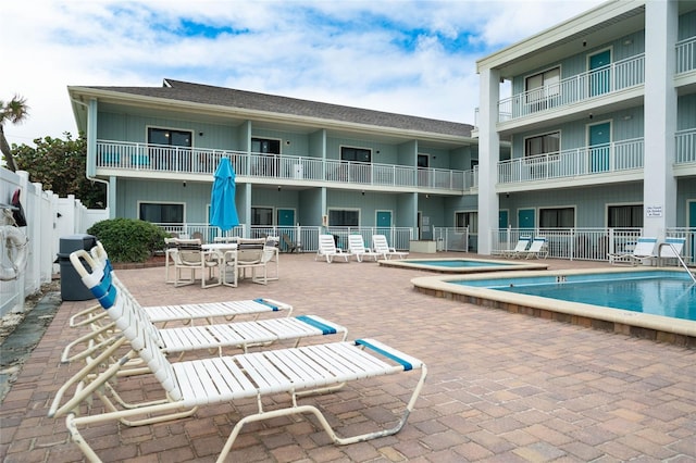 3509 S Atlantic Ave Unit 102And 103, New Smyrna Beach, FL 32169 - community pool featuring a jacuzzi, a patio, and fence