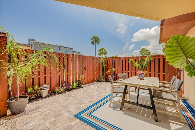 view of patio with outdoor dining space and a fenced backyard