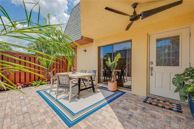 view of patio / terrace featuring fence, a ceiling fan, and outdoor dining area
