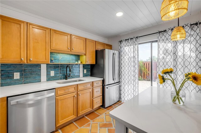 kitchen with stainless steel appliances, a sink, light countertops, decorative backsplash, and recessed lighting