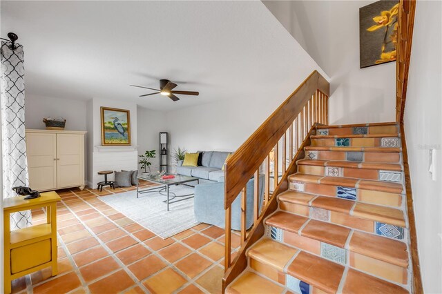 staircase featuring ceiling fan and tile patterned floors