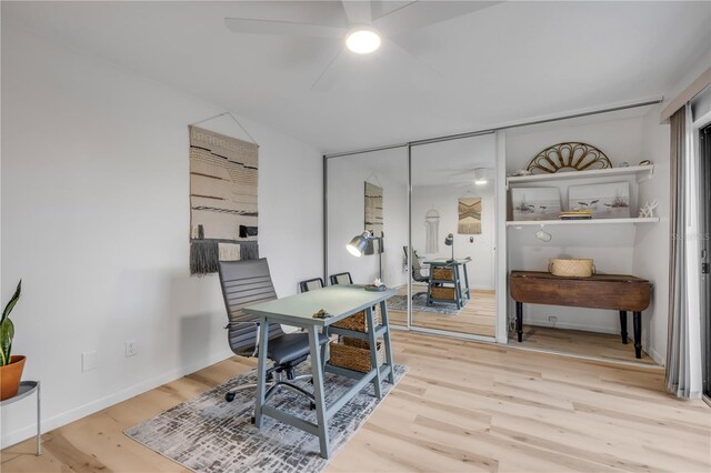 office space featuring a ceiling fan, wood finished floors, and baseboards