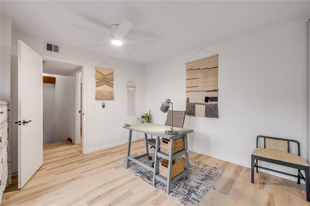 office area featuring a ceiling fan, light wood-style flooring, and baseboards