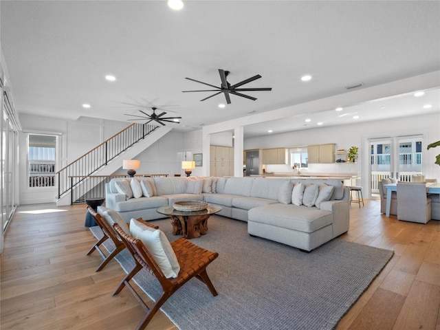 living area with light wood-style floors, stairway, recessed lighting, and ceiling fan