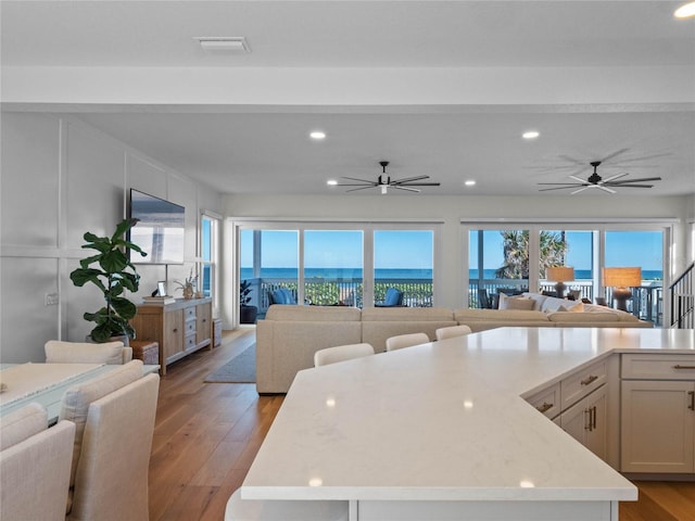 kitchen with open floor plan, recessed lighting, ceiling fan, and light wood finished floors