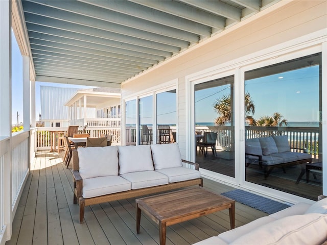 wooden deck featuring an outdoor hangout area and a water view