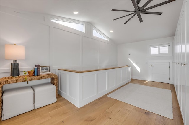 interior space with ceiling fan, light wood-style floors, a decorative wall, and recessed lighting