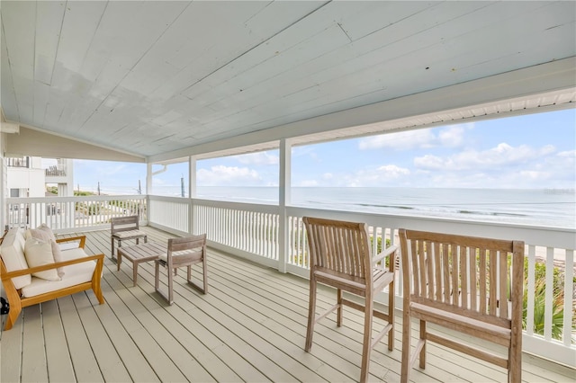 deck with view of water and beach