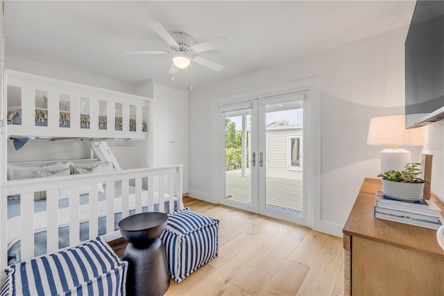 bedroom with light wood-type flooring, baseboards, access to outside, and french doors