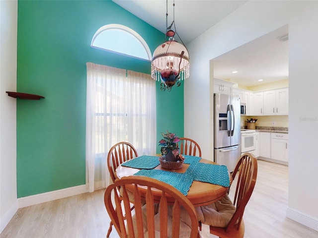 dining room with light wood-style floors and baseboards