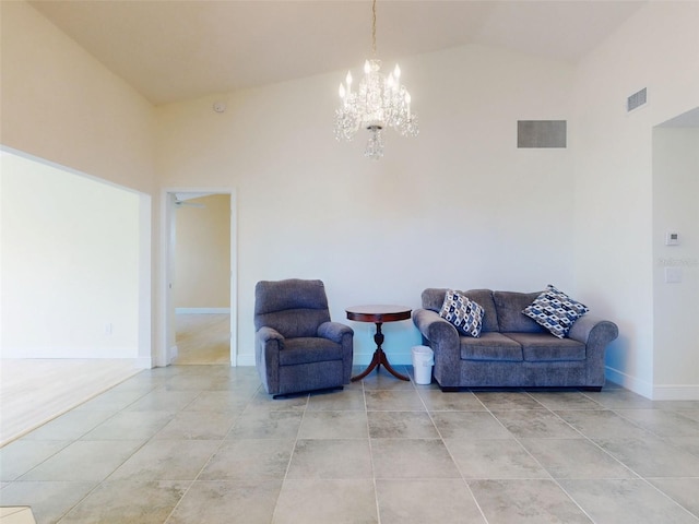living area featuring light tile patterned floors, a chandelier, baseboards, and vaulted ceiling