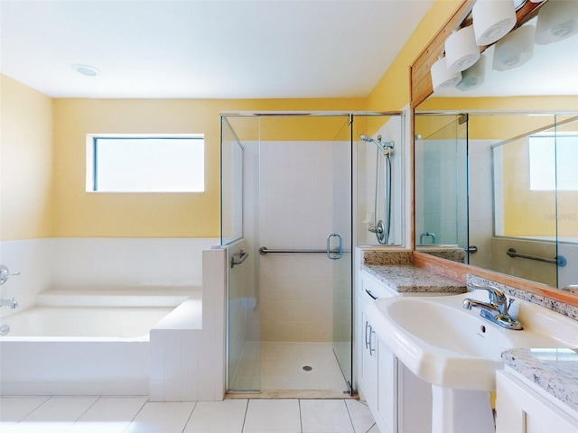 bathroom featuring a shower stall, a bath, and tile patterned flooring