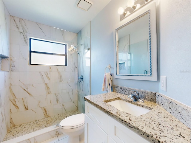 full bathroom with a marble finish shower, toilet, and vanity