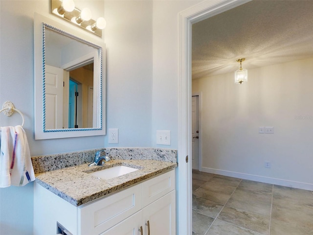 bathroom with vanity and baseboards