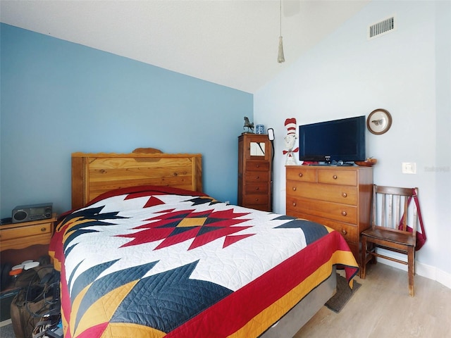 bedroom with wood finished floors, vaulted ceiling, baseboards, and a ceiling fan