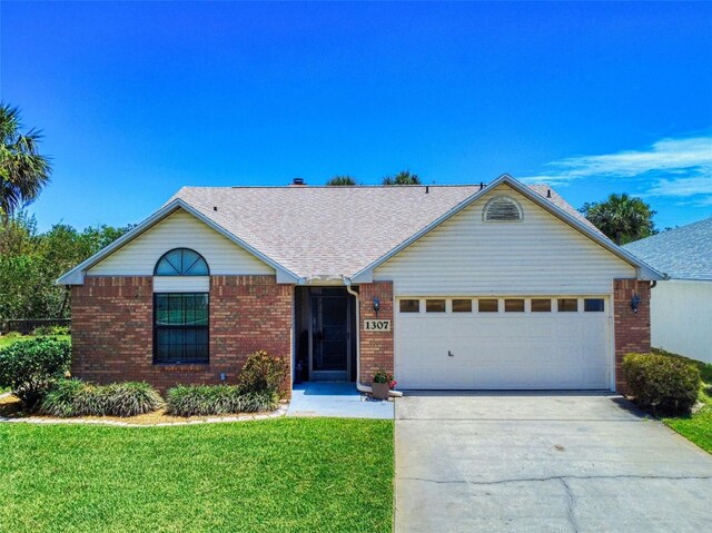 ranch-style house with brick siding, a garage, concrete driveway, and a front lawn