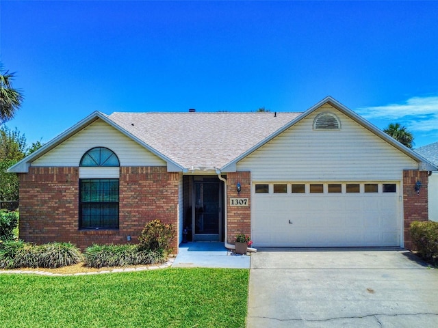 ranch-style home with an attached garage, brick siding, driveway, and a front yard