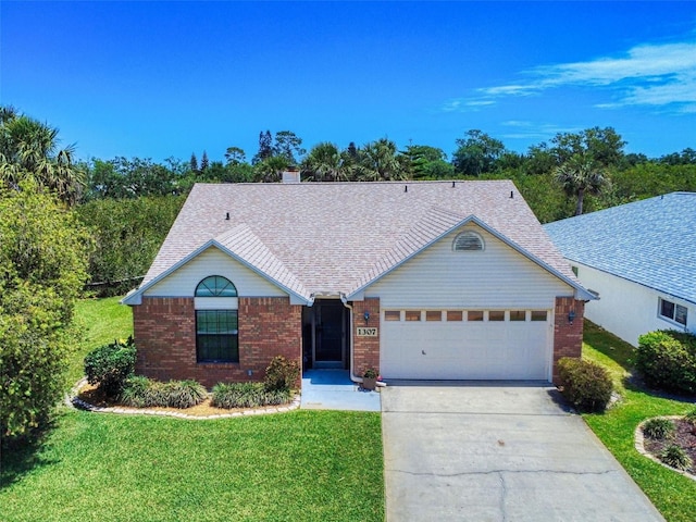 ranch-style home featuring an attached garage, concrete driveway, a front lawn, and brick siding