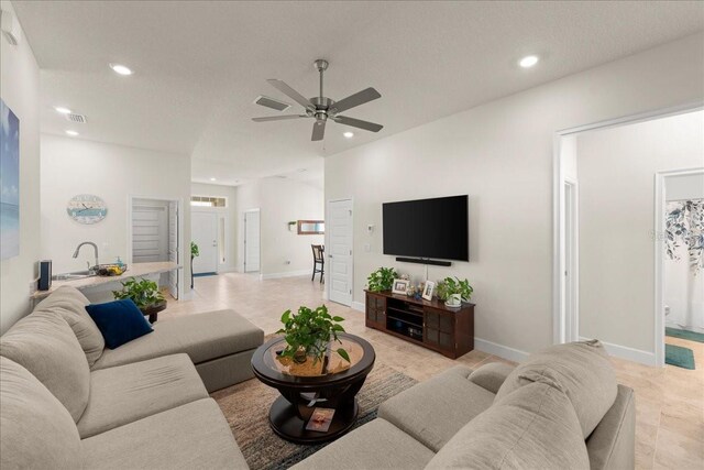 living area with ceiling fan, recessed lighting, and baseboards