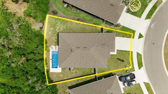 aerial overview of property's location with property boundaries highlighted and a pool