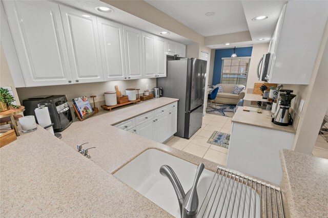 kitchen featuring stainless steel appliances, white cabinets, light countertops, recessed lighting, and light tile patterned flooring