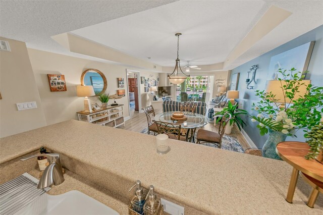 dining space featuring light wood-type flooring and a ceiling fan
