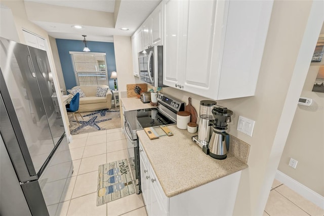 kitchen with stainless steel appliances, white cabinets, light tile patterned flooring, recessed lighting, and baseboards
