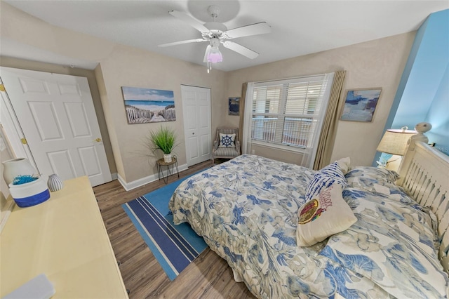 bedroom featuring wood finished floors, a closet, a ceiling fan, and baseboards