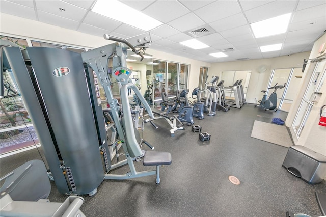 exercise room with a paneled ceiling