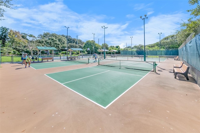 view of tennis court featuring fence